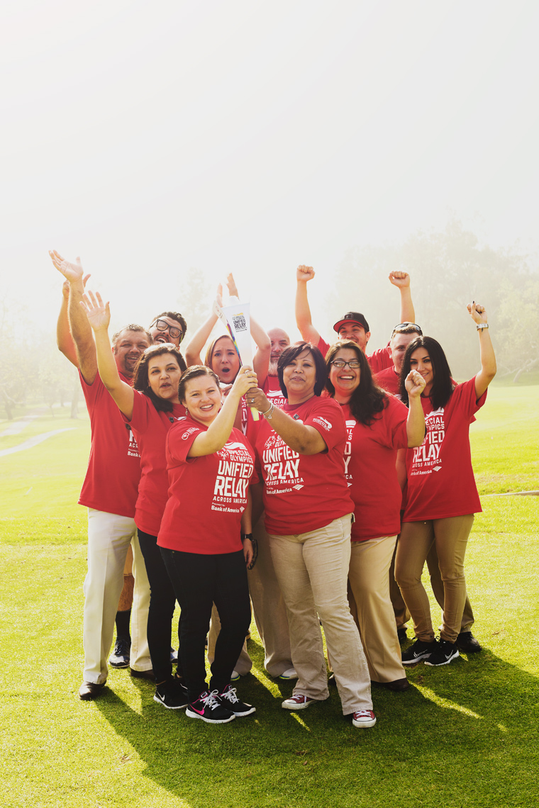 bank of america employees holding special olympics torch on golf course, washington dc commercial photography
