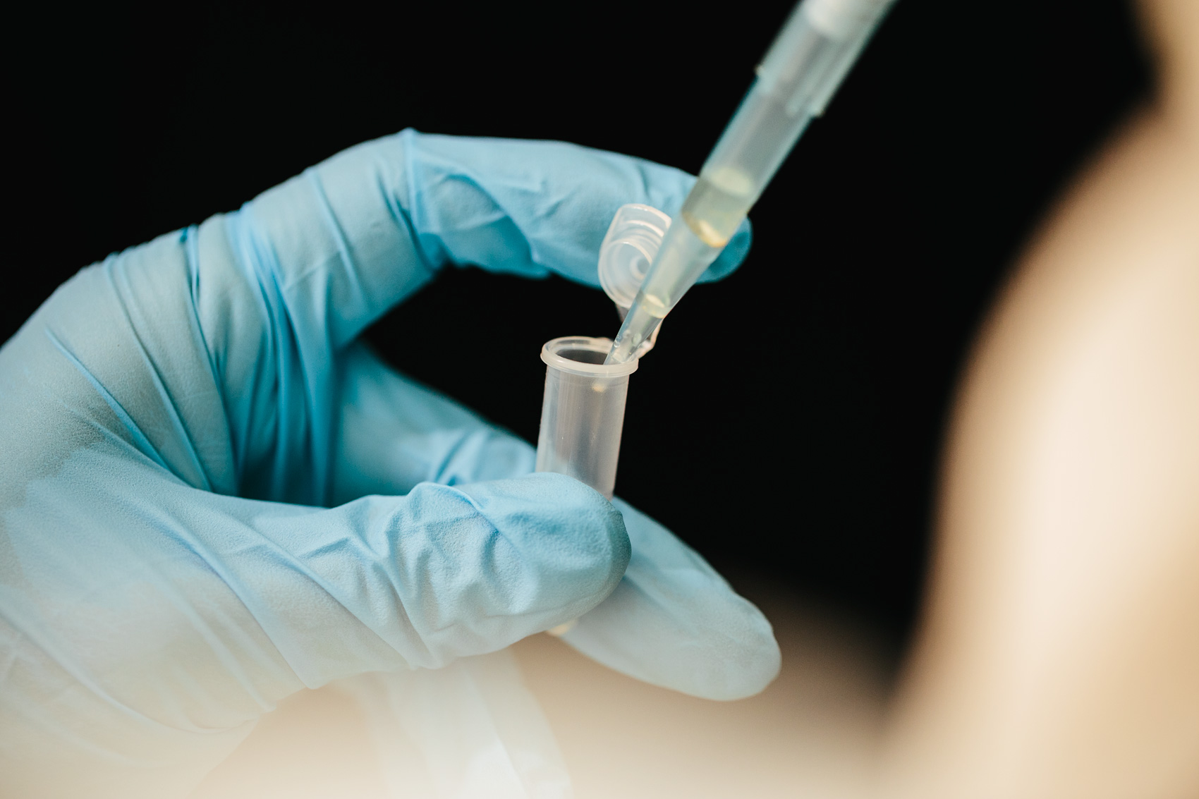 gloved hand with test tube for washington dc commercial photography