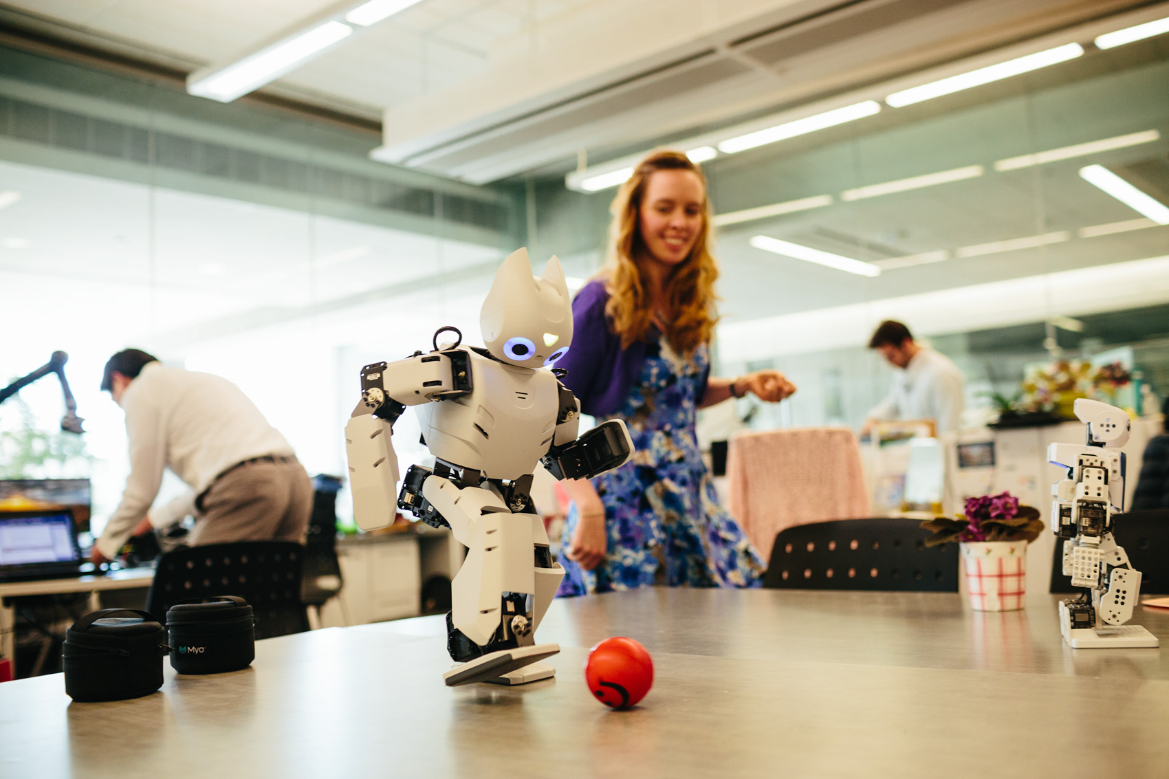 small robot kicking ball on desk, washington dc university photography