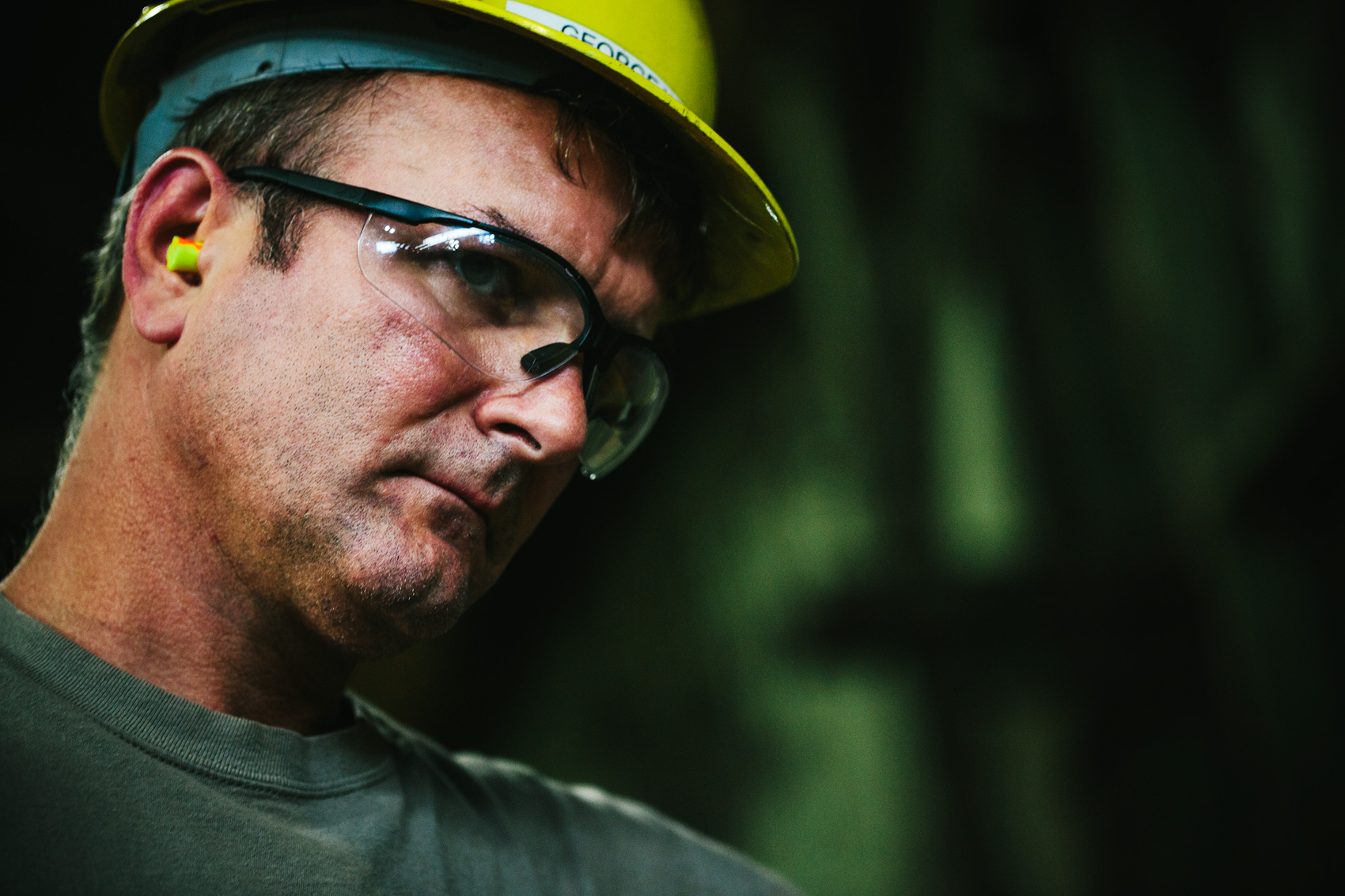 steel mill worker wearing earplugs for washington dc industrial photography