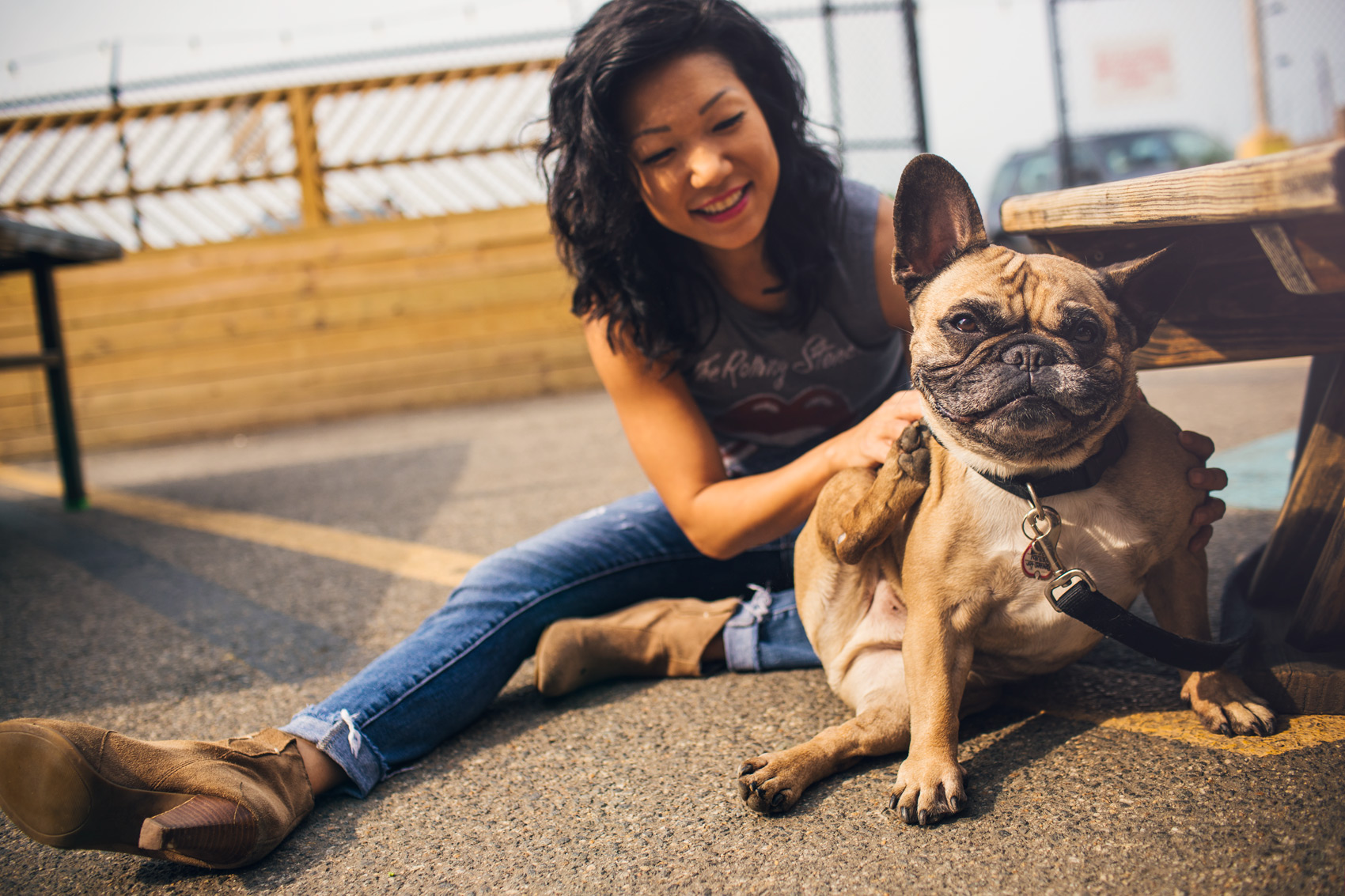 woman petting pug sitting on street for washington dc lifestyle photography