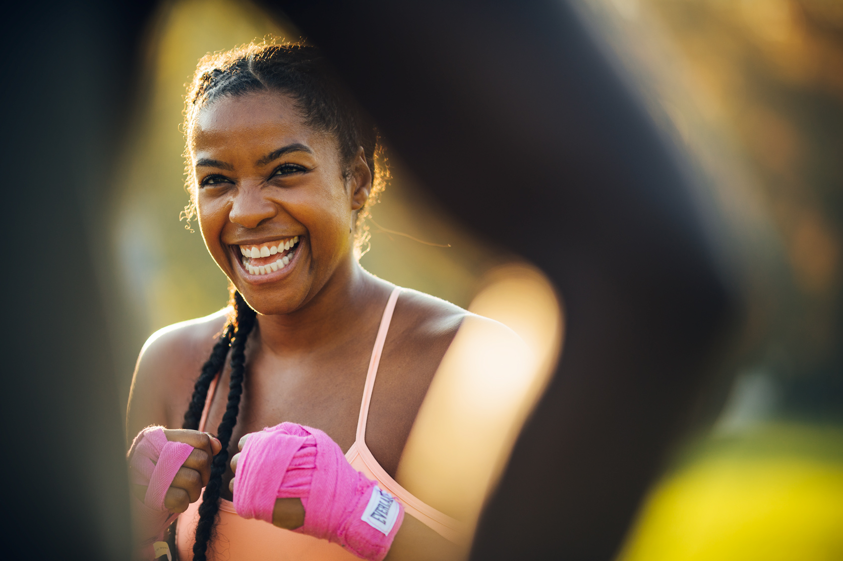 woman laughing with pink boxing wraps for washington dc commercial photography