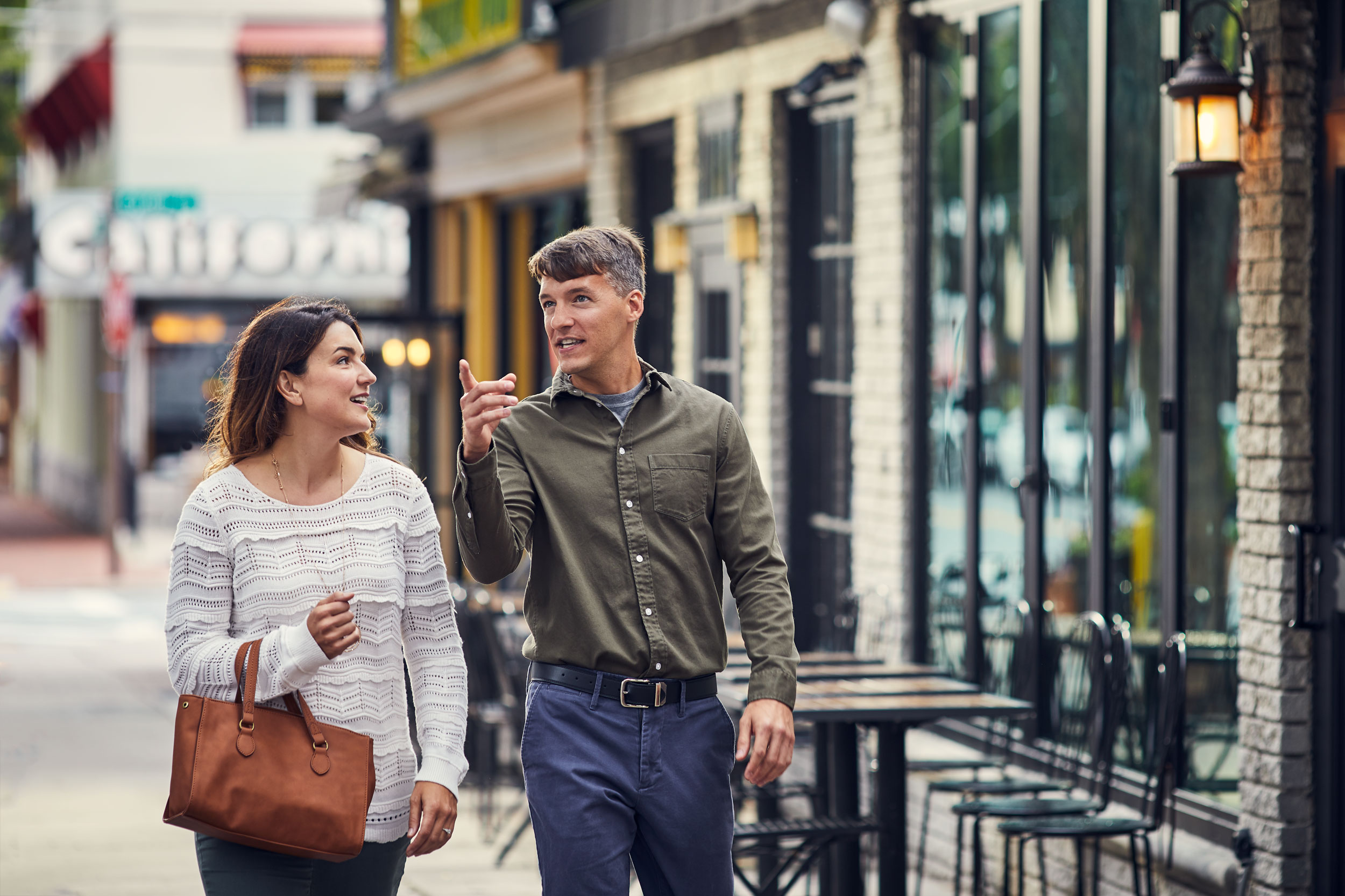 couple talking and walking on sidewalk, washington dc commercial photography