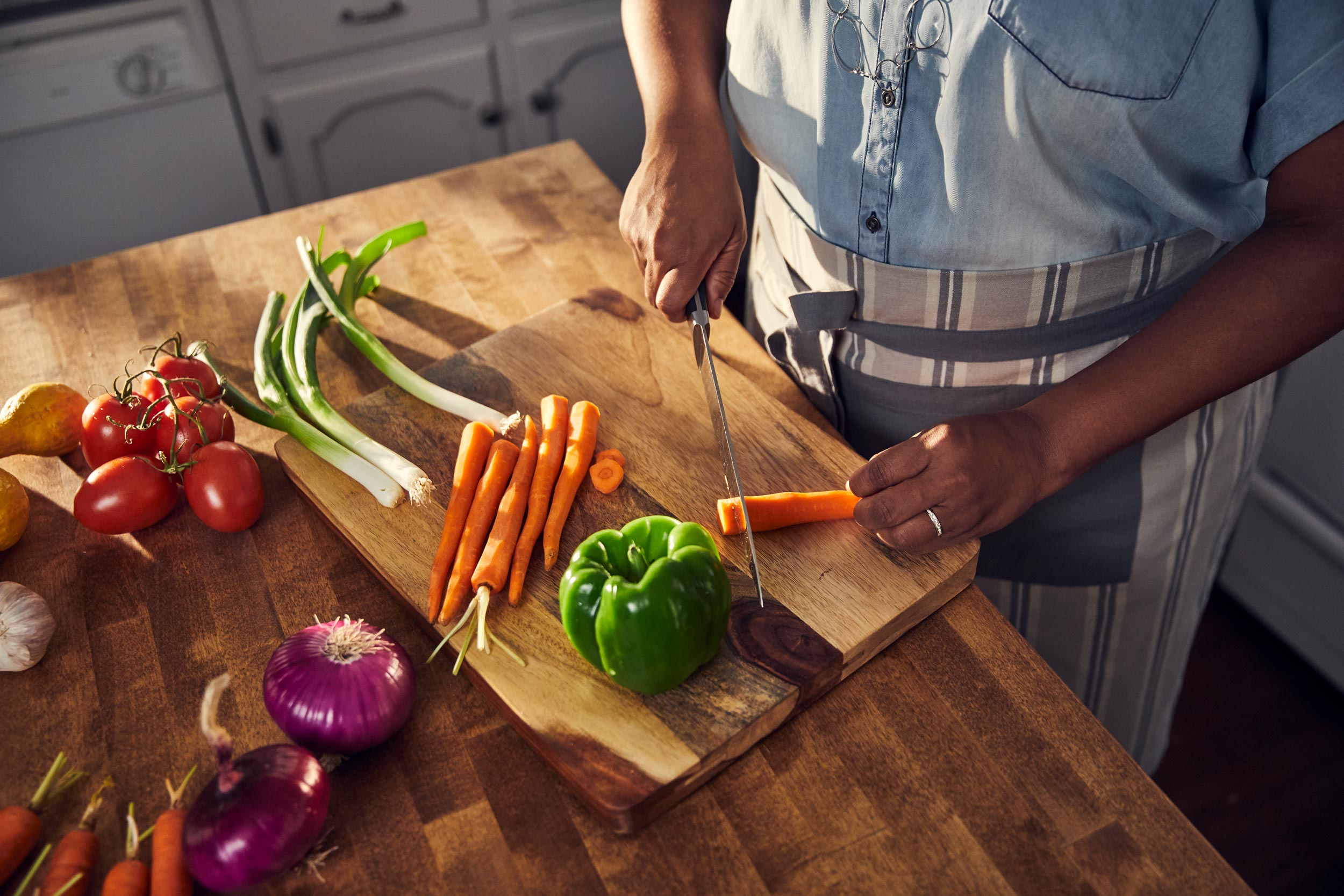 hands cutting carrot on cutting board, washington dc commercial photography