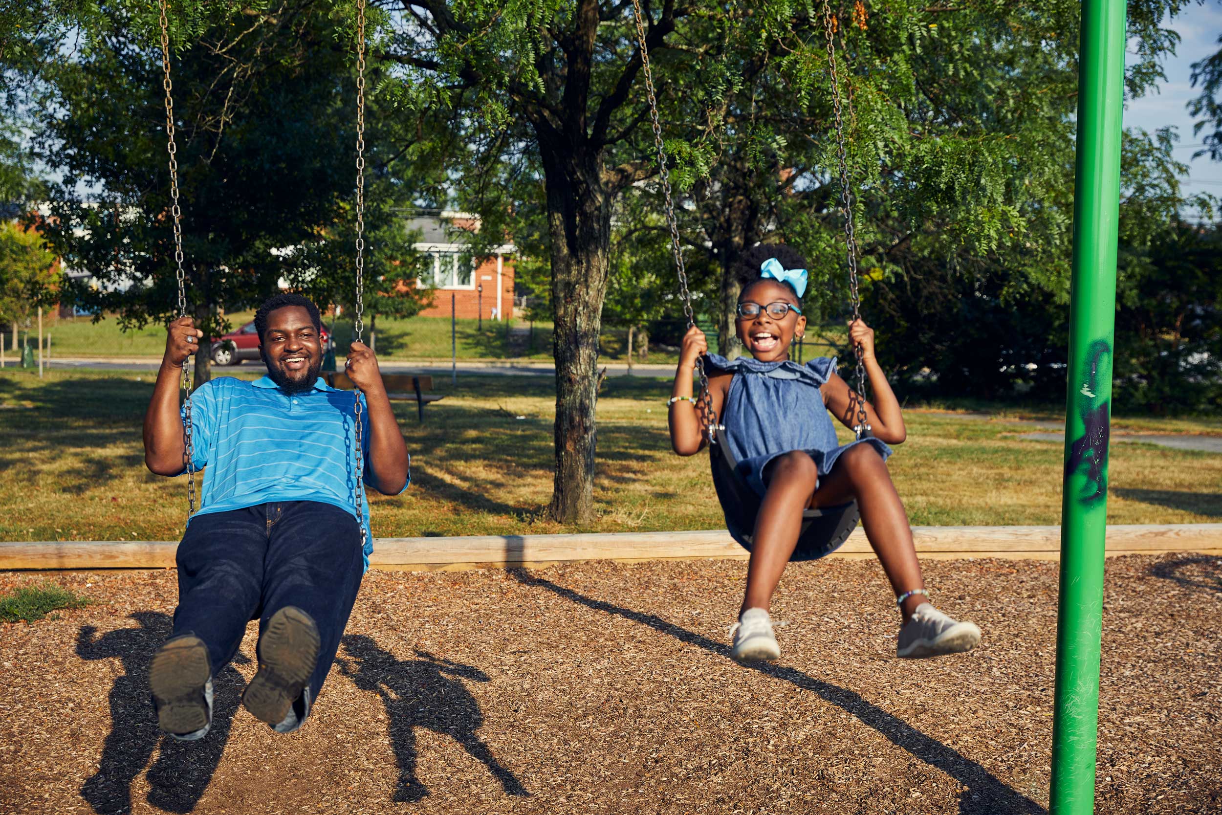 father and daughter swinging on playground, washington dc commercial photography