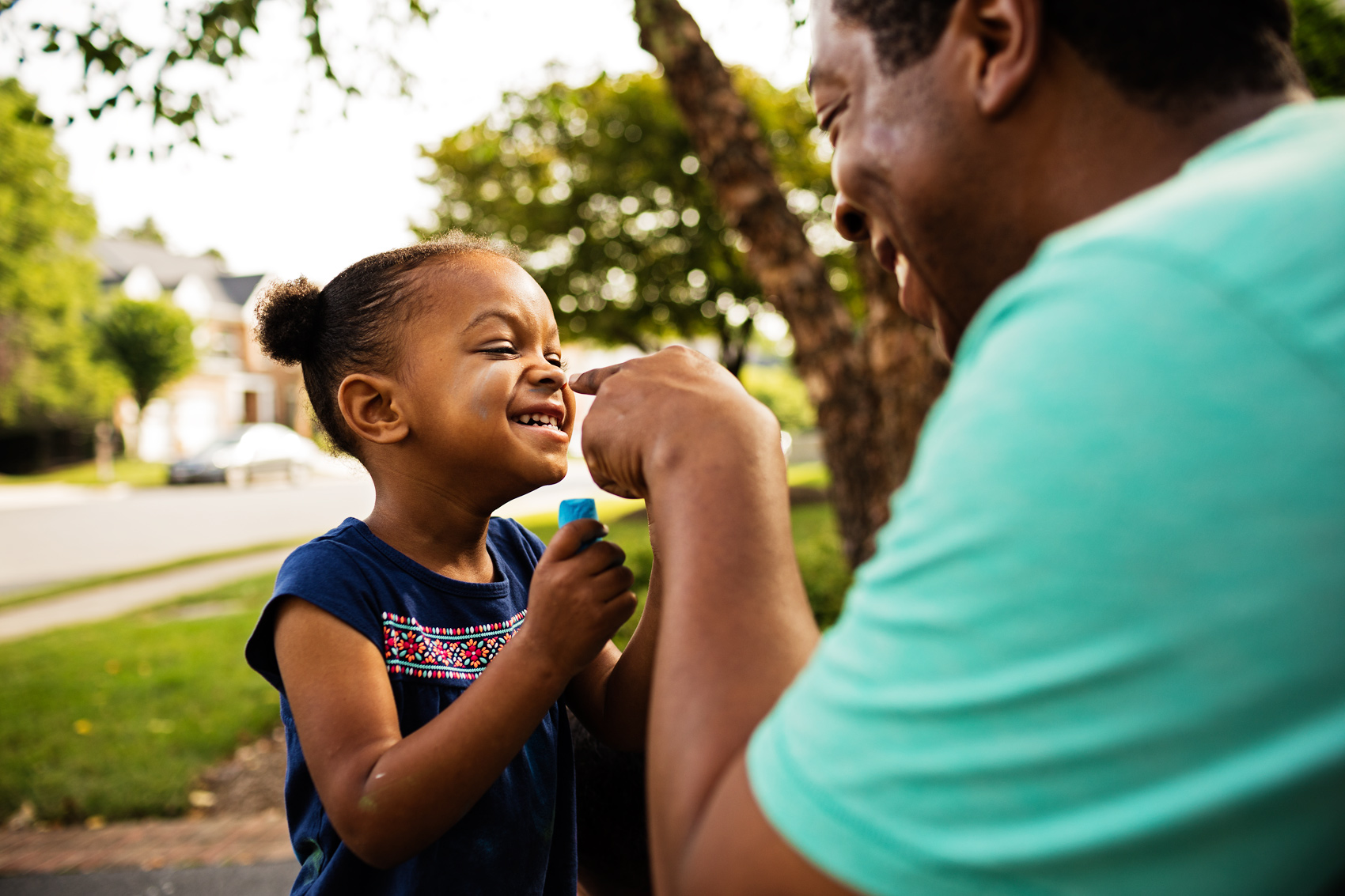 father pointing finger at laughing daughter, washington dc commercial photography