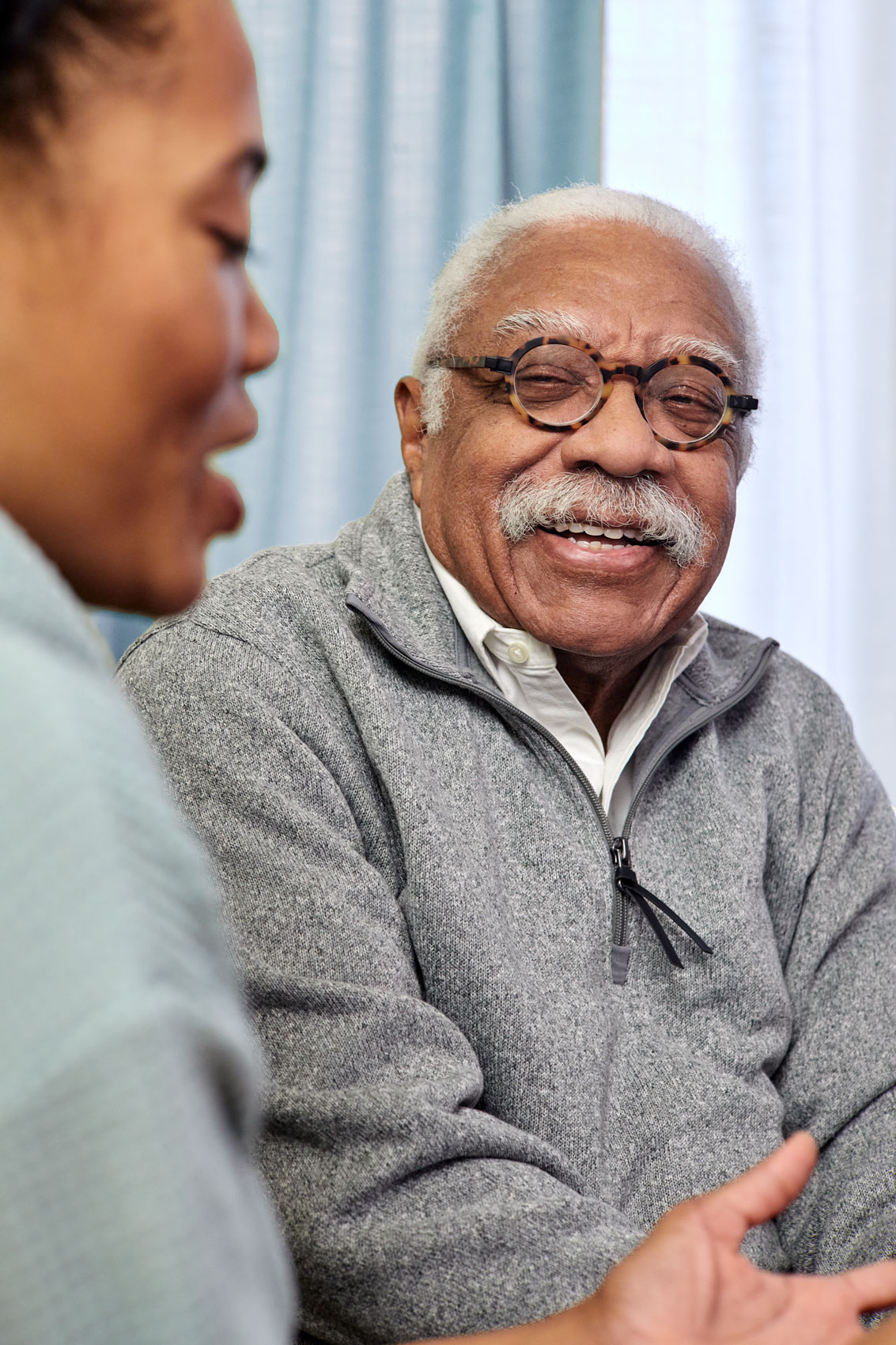 elderly-man-listening-to-younger-daughter-dmv-advertising-photography-eli-meir-kaplan