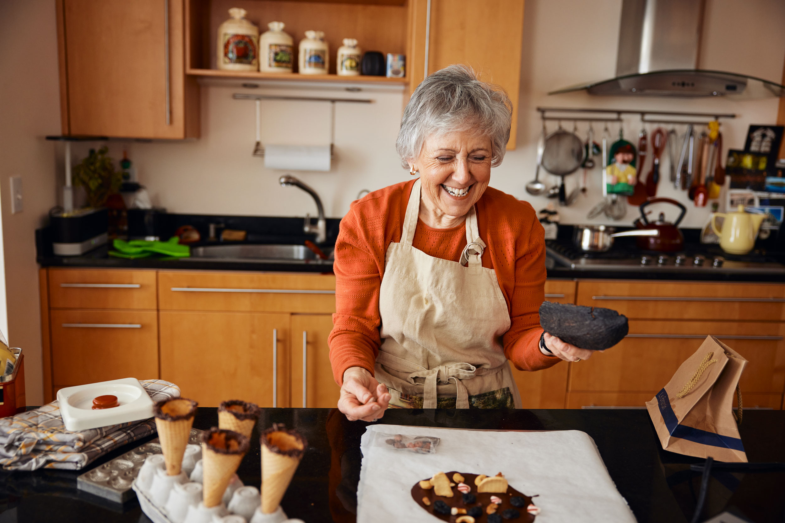 gray-haired-woman-laughing-kitchen-new-york-natural-moment-commercial-photography