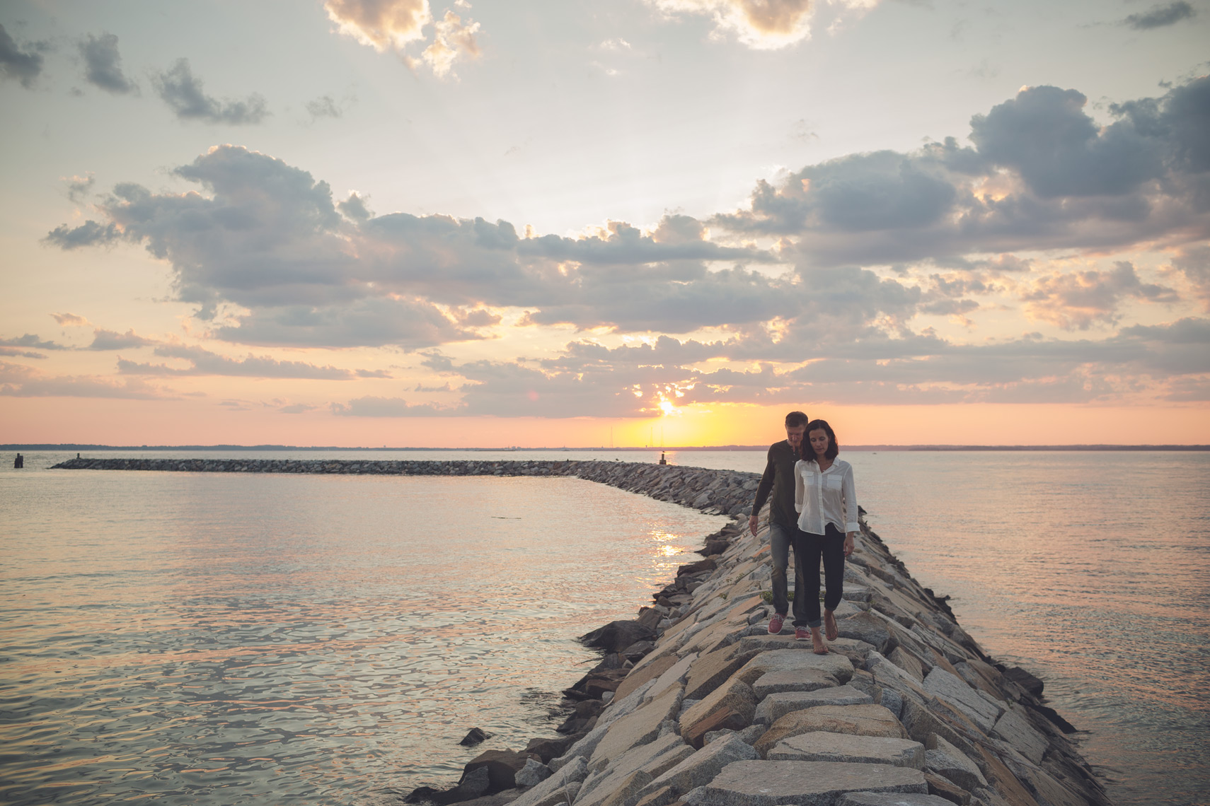 man and woman walk on jetty for washington dc lifestyle photography