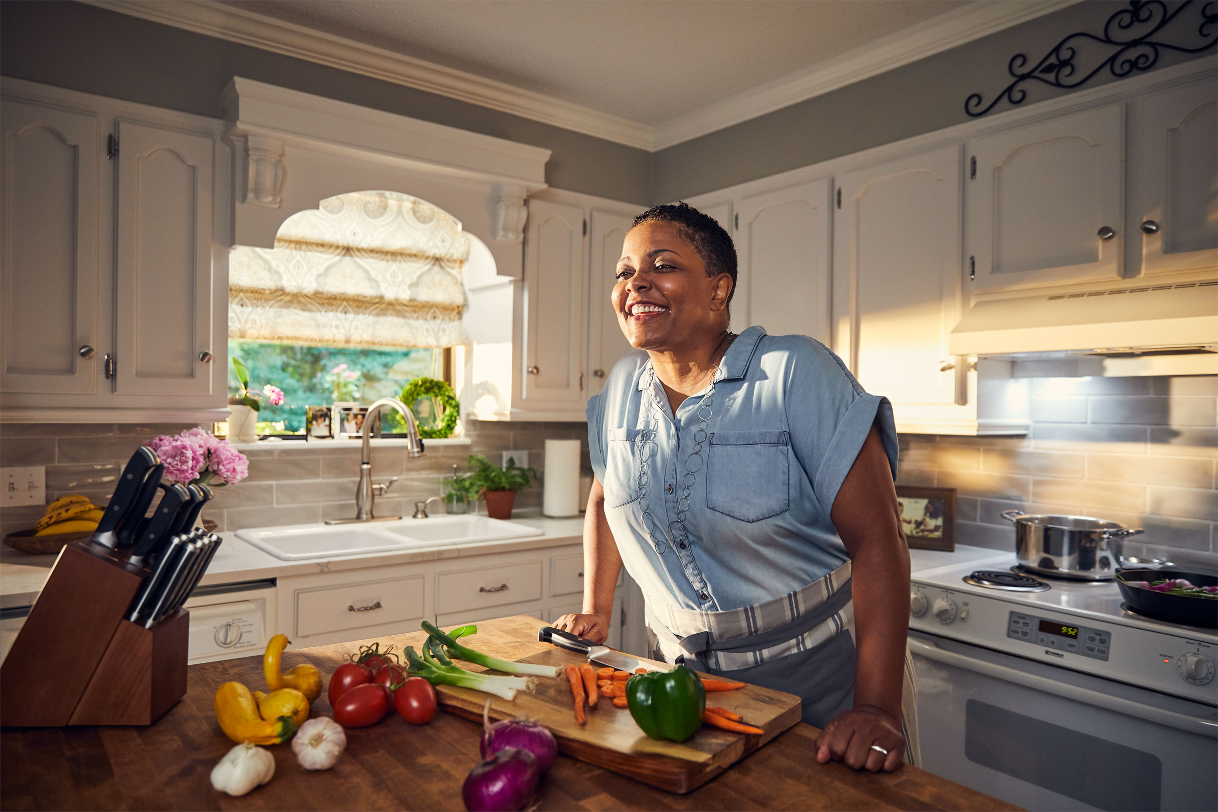 smiling woman at cutting board in kitchen, washington dc commercial photography