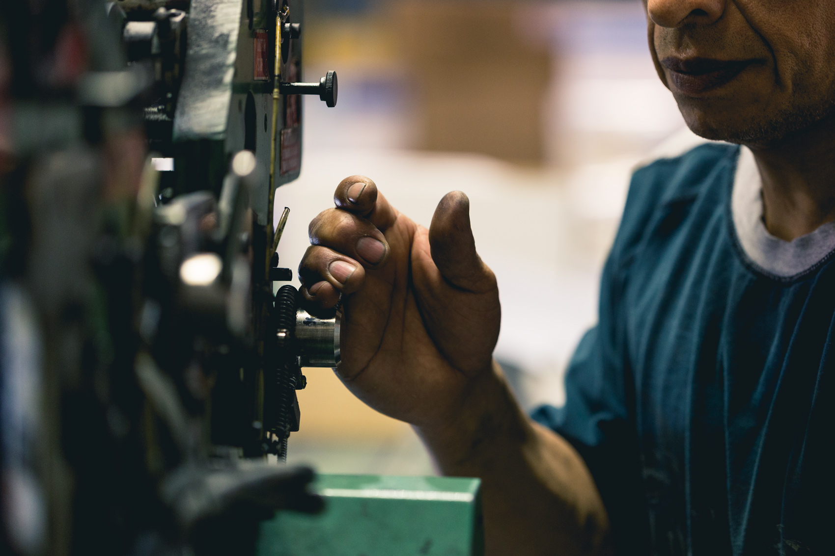 A mailroom worker works a labeling machine at a printing press in Alexandria, Virginia.