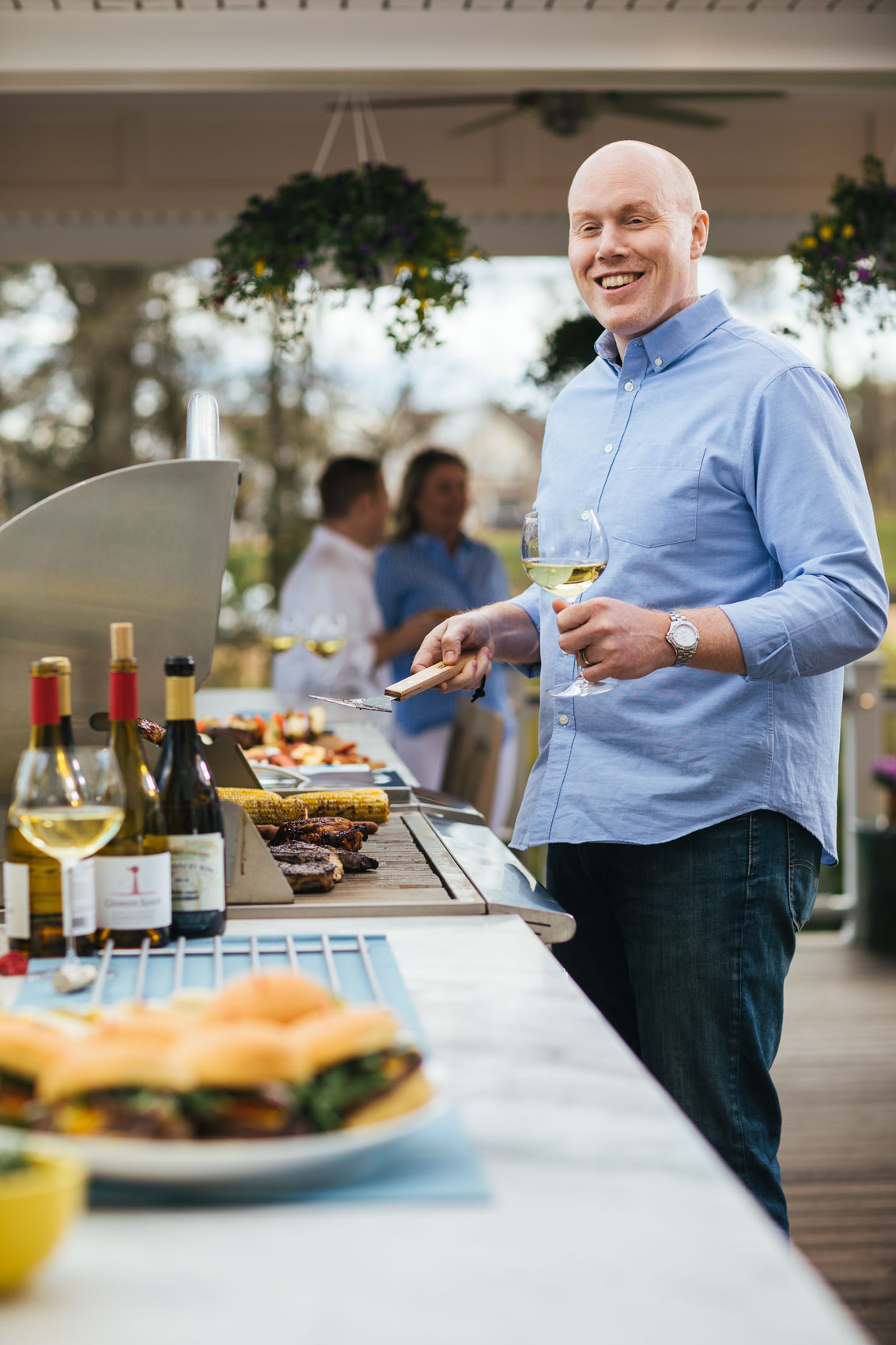 man-grilling-holding-wine-glass