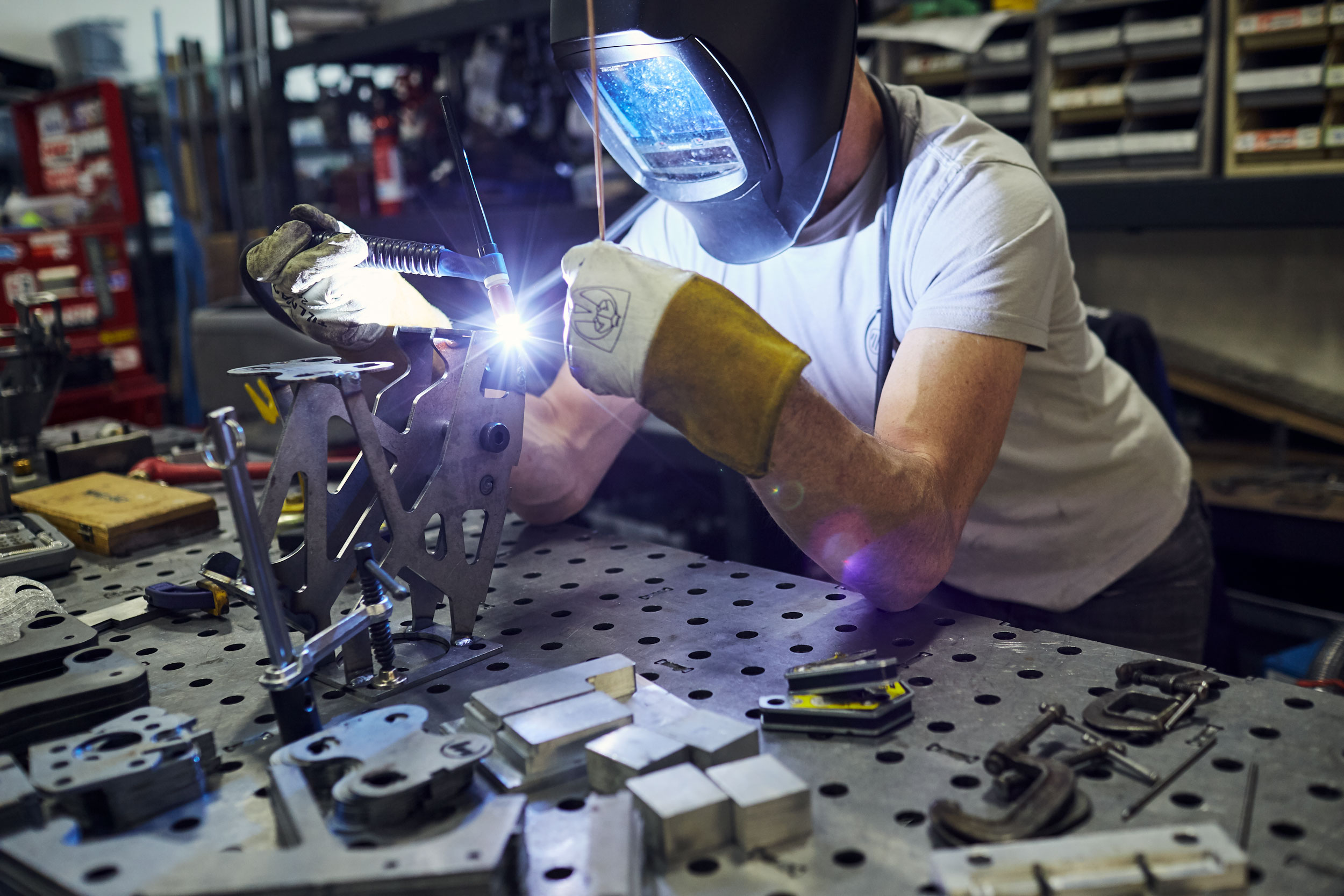 man welding car parts, washington dc industrial photography
