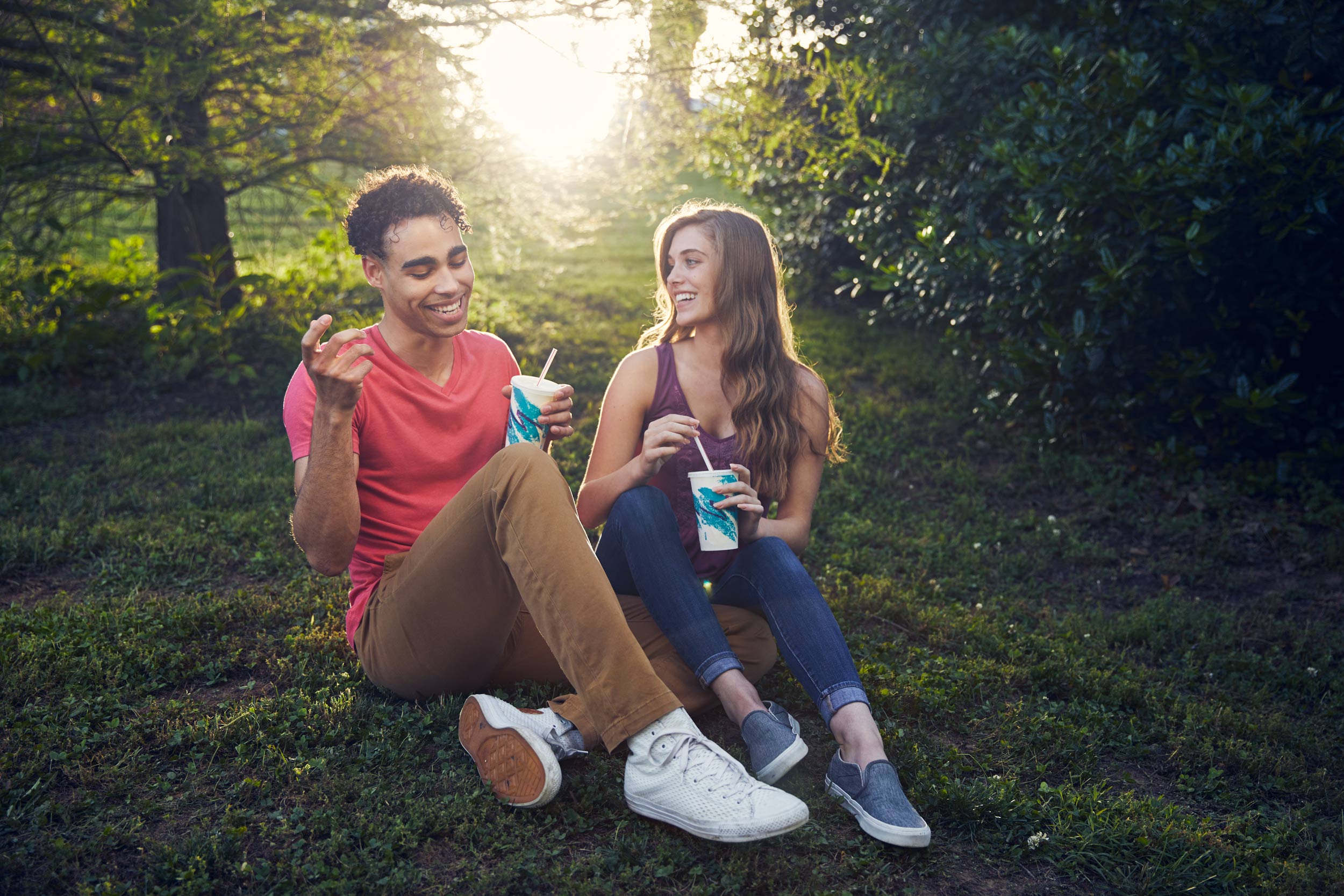millennials sharing milkshake in park for washington dc commercial photography