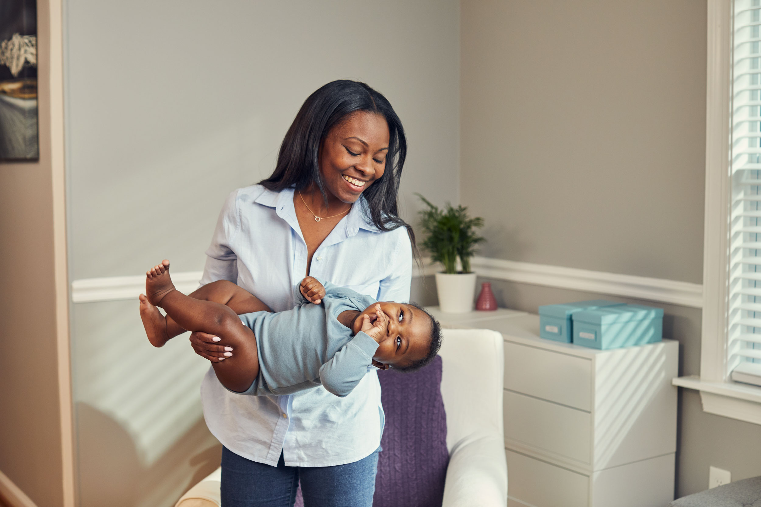mom swinging baby in room, washington dc commercial photography