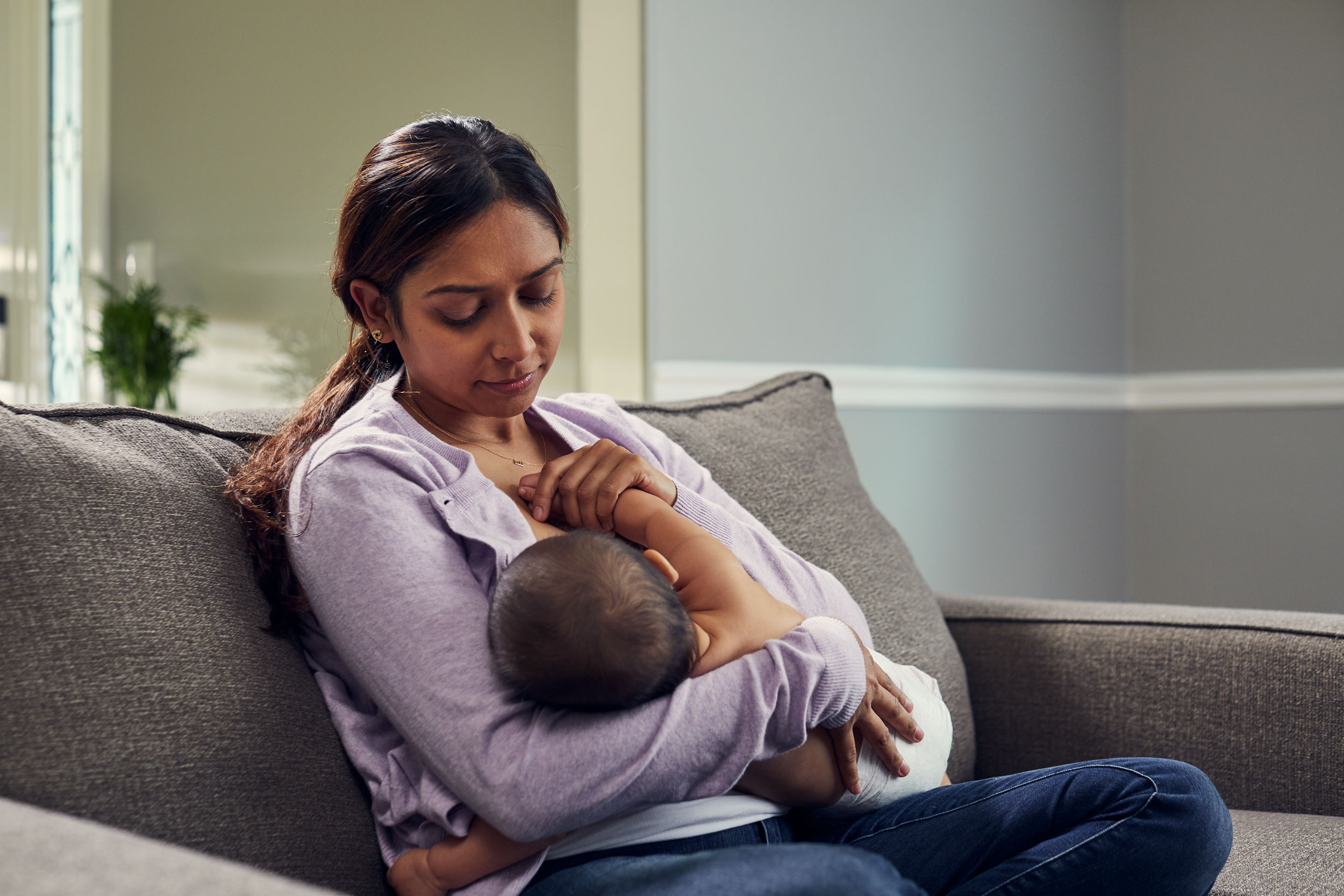 mom  breastfeeding baby on couch, washington dc commercial photography