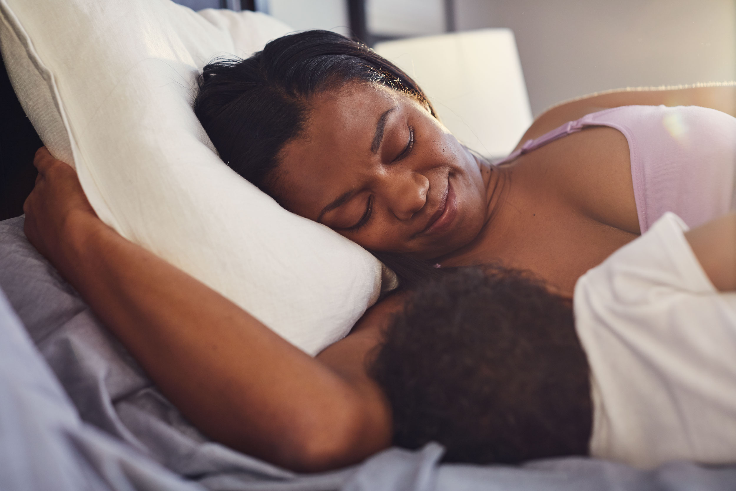 mom nursing baby on side in bed, washington dc commercial photography