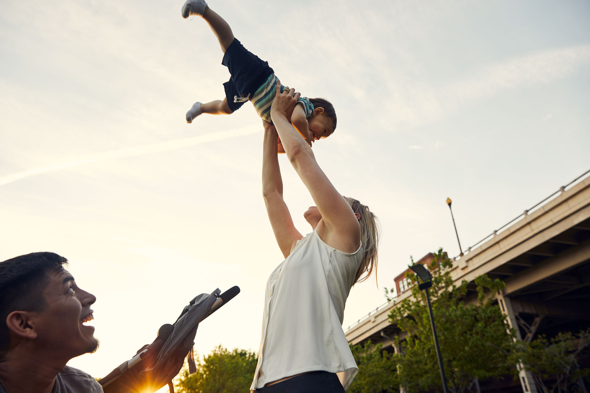 mom tossing toddler in sky for washington dc commercial photography