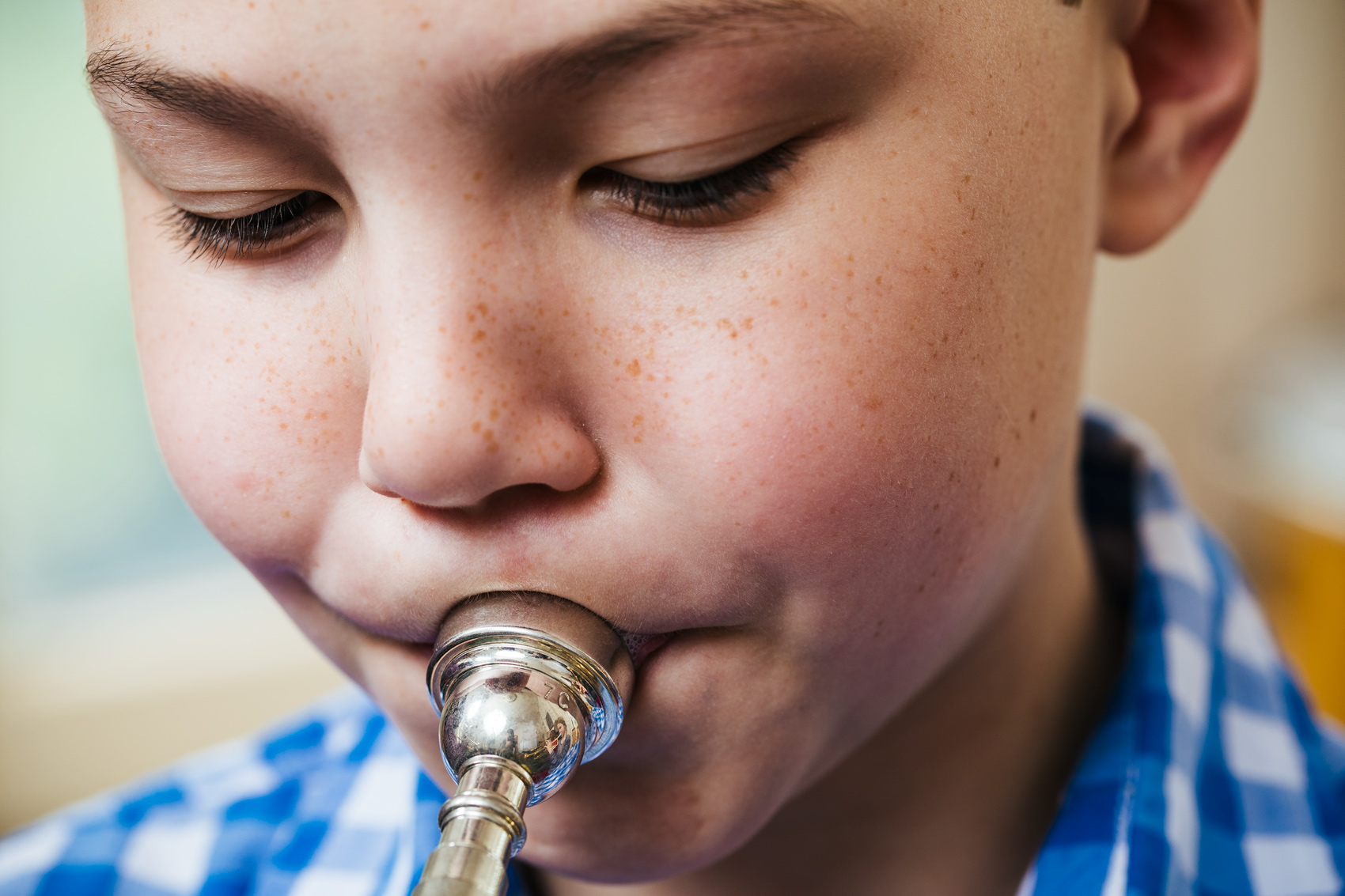 young male trumpet playing blowing horn with big cheeks, washington dc commercial photography