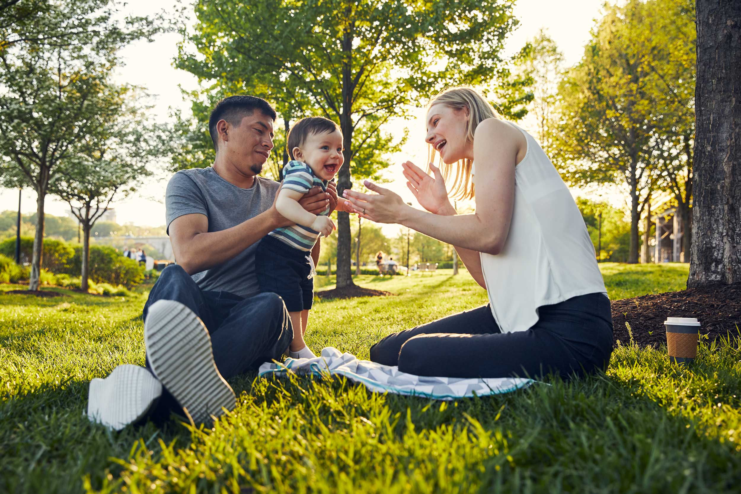 parents with baby boy in park for washington dc lifestyle photography