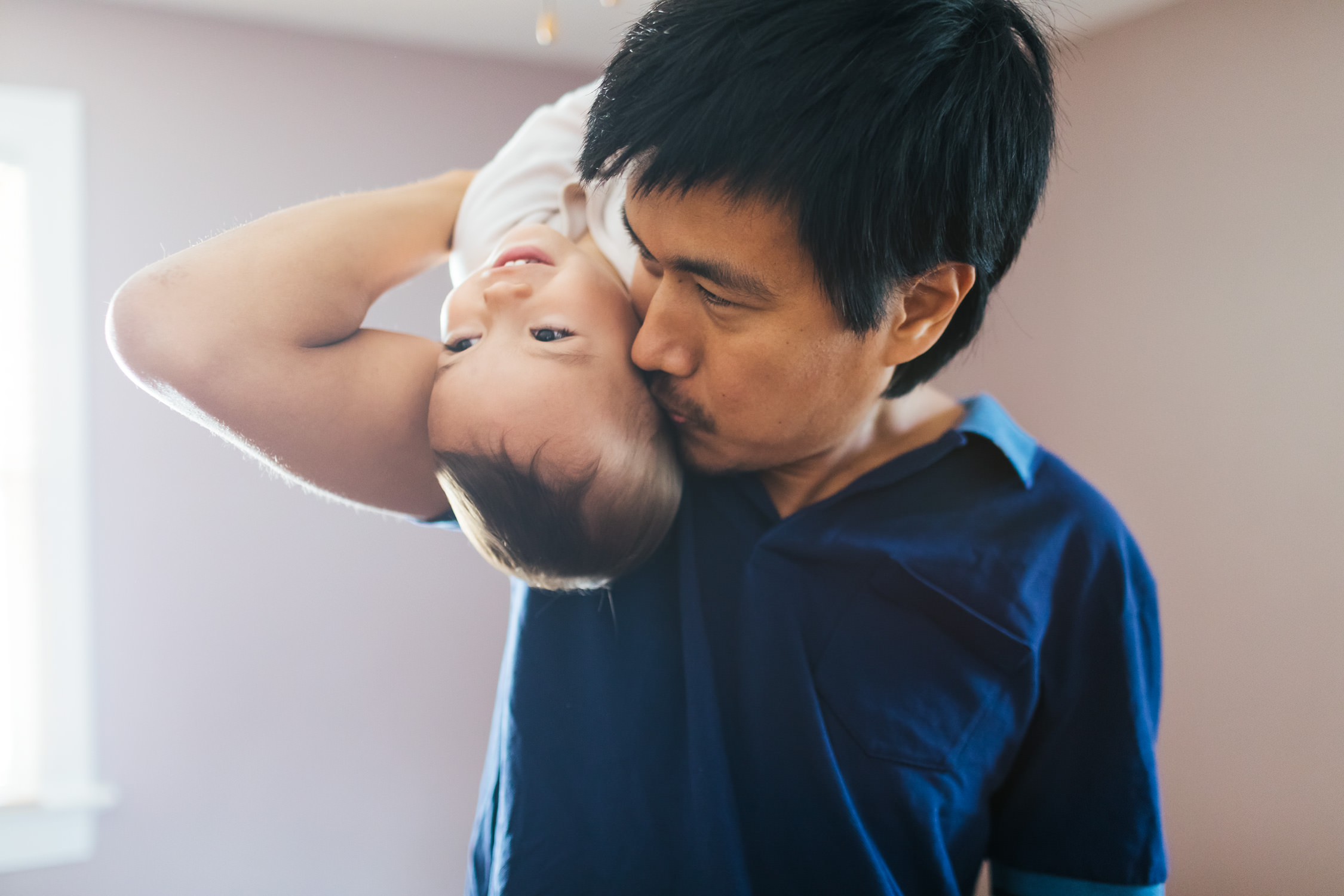 dad kissing toddler daughter on shoulder, washington dc commercial photography