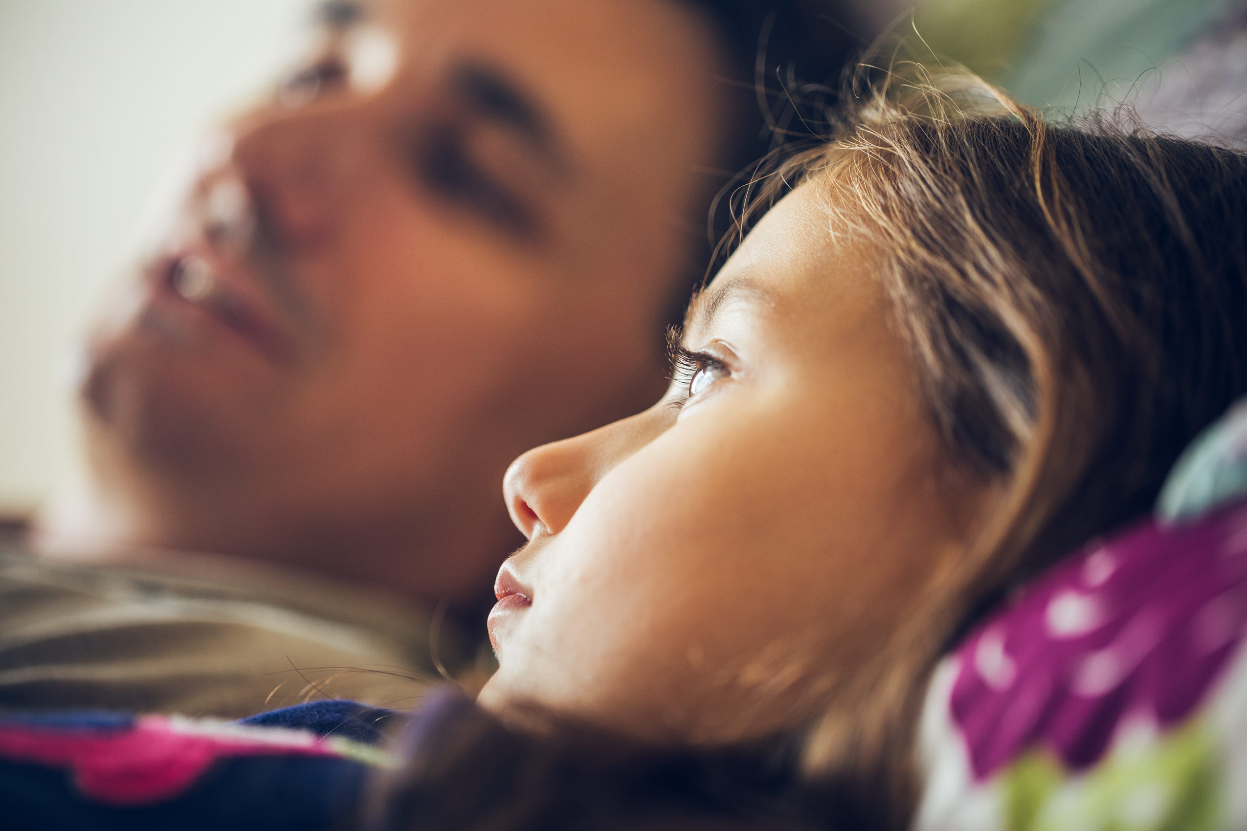 daughter lying on pillow with dad, washington dc commercial photography