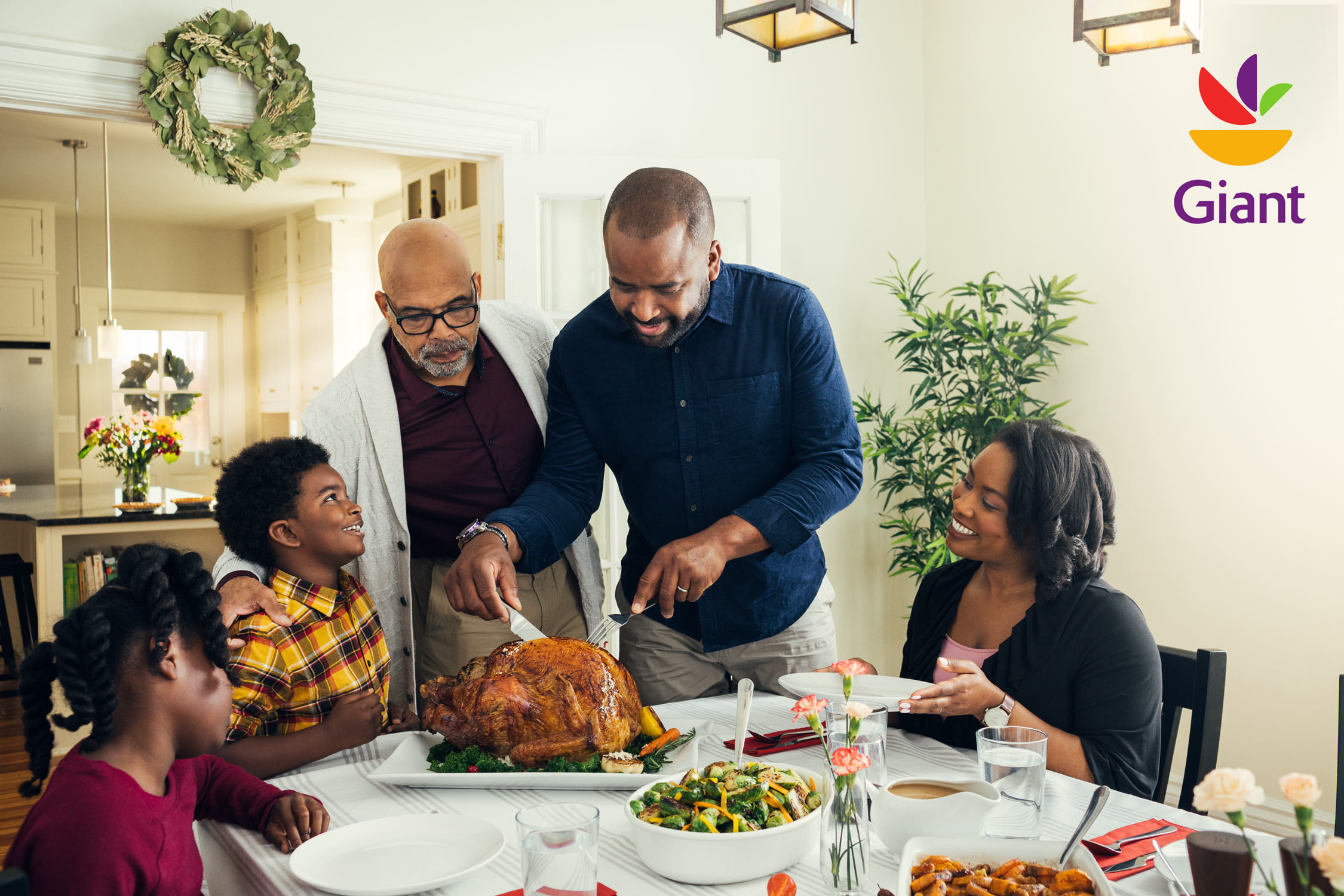 family carving turkey for holidays in dining room, washington dc commercial photography