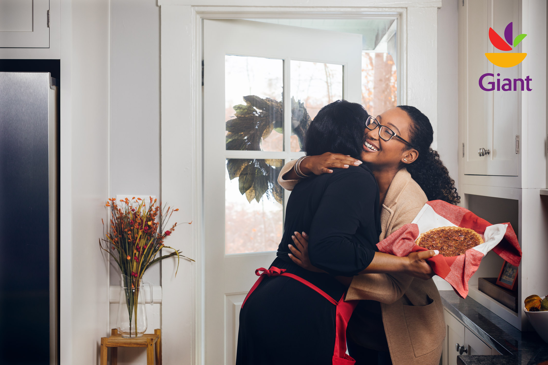 two women greeting at door with pie, washington dc commercial photography