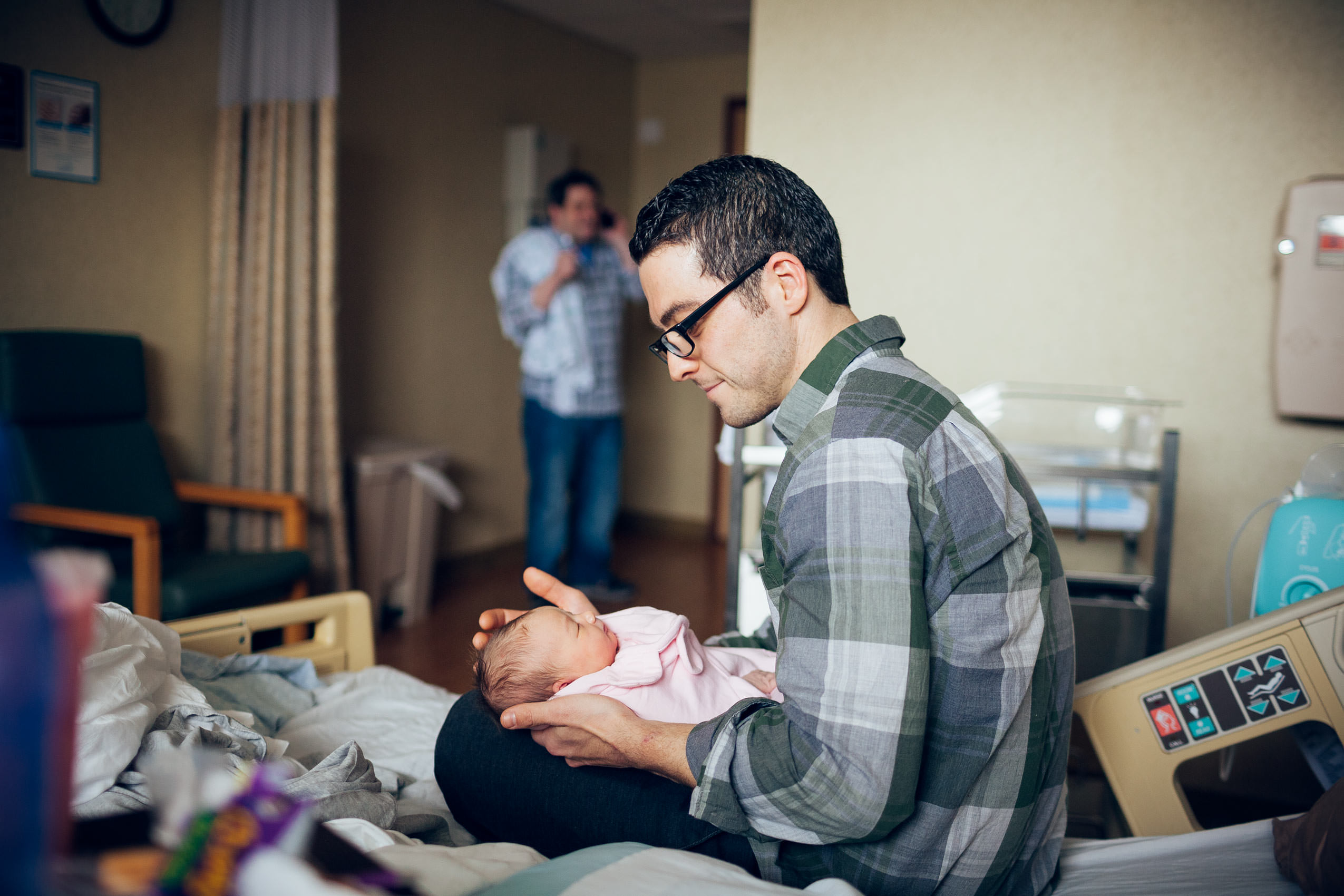 father with newborn baby in hospital for washington dc commercial photography