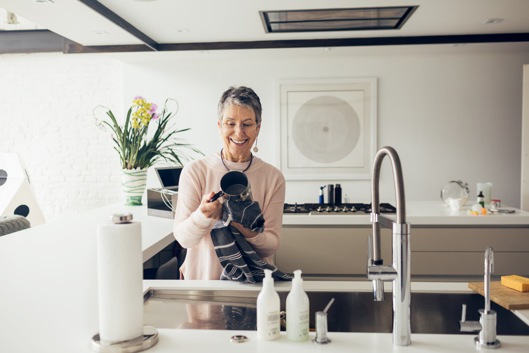 mature woman washing dishes in kitchen, washington dc commercial photography
