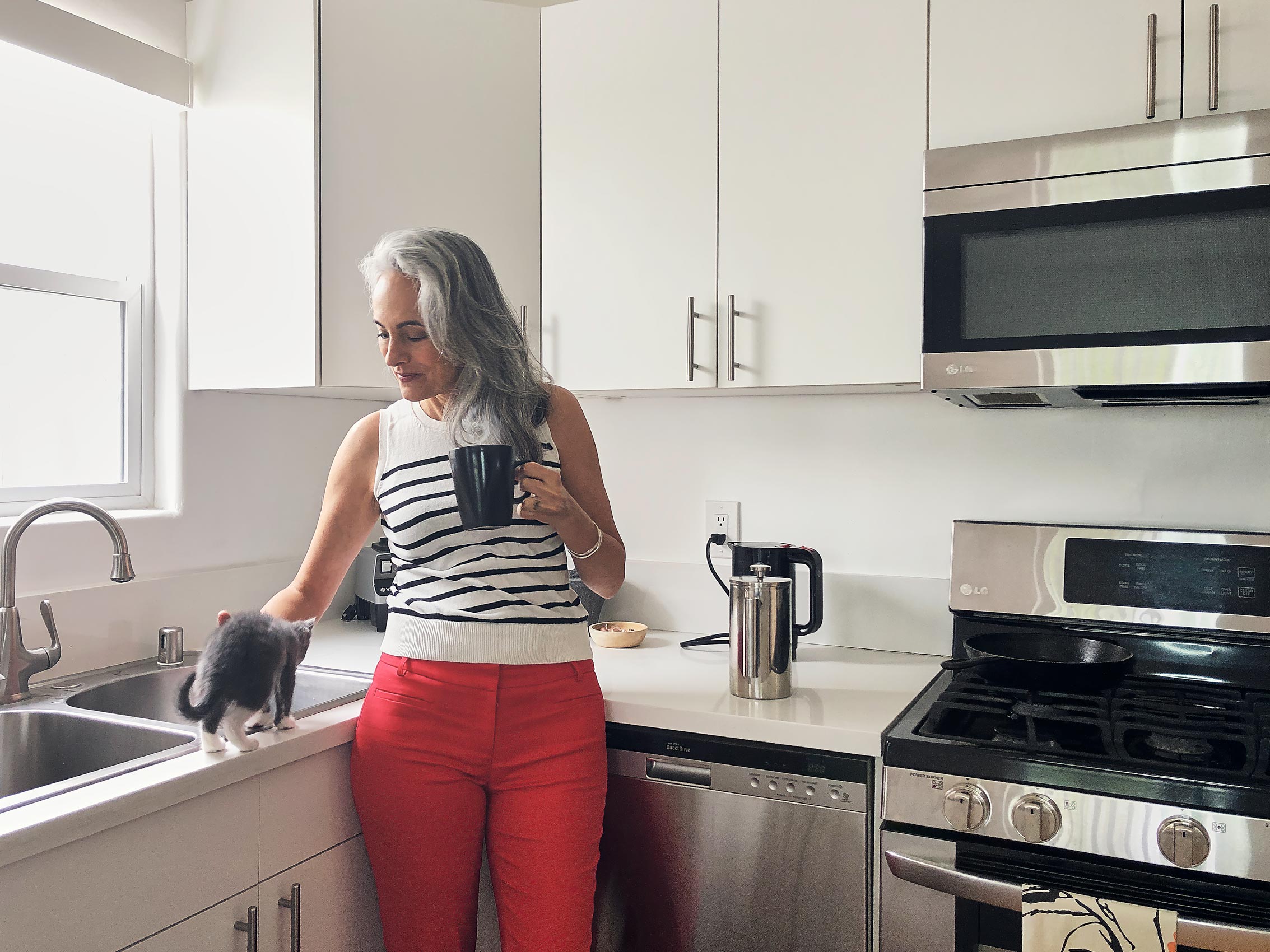 woman with silver hair in kitchen, remote photography